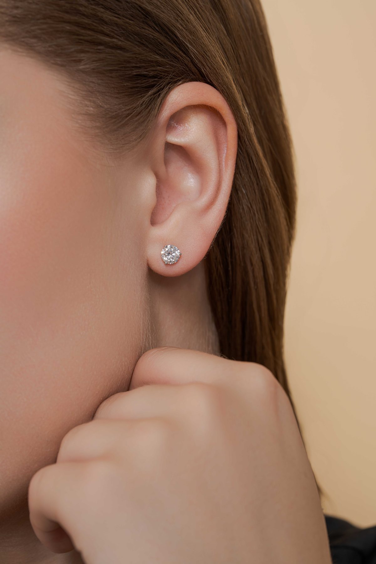 Round diamond solitaire stud earring, modeled